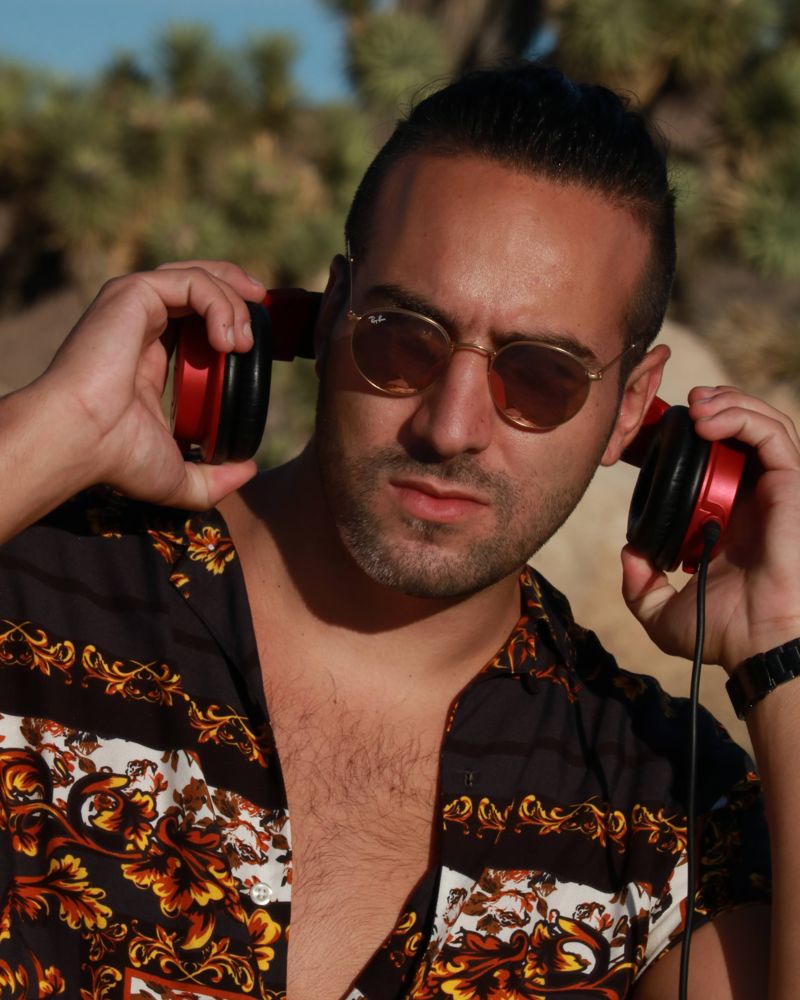 Güney Tamer wearing red studio headphones
